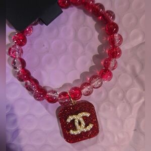 Elegant Red Stretch Beaded Bracelet Iconic Logo Glitter Charm